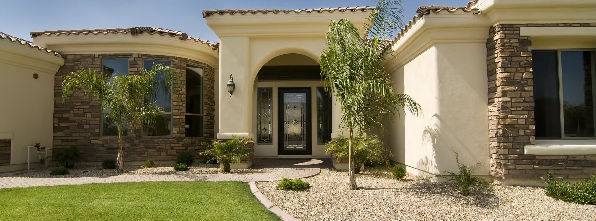 Mediterranean stucco home exterior with palm trees